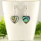 Heart Shaped Abalone Shell Earrings displayed on a tea cup.