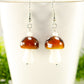 Close up of Brown Mushroom Glass Bead Earrings.