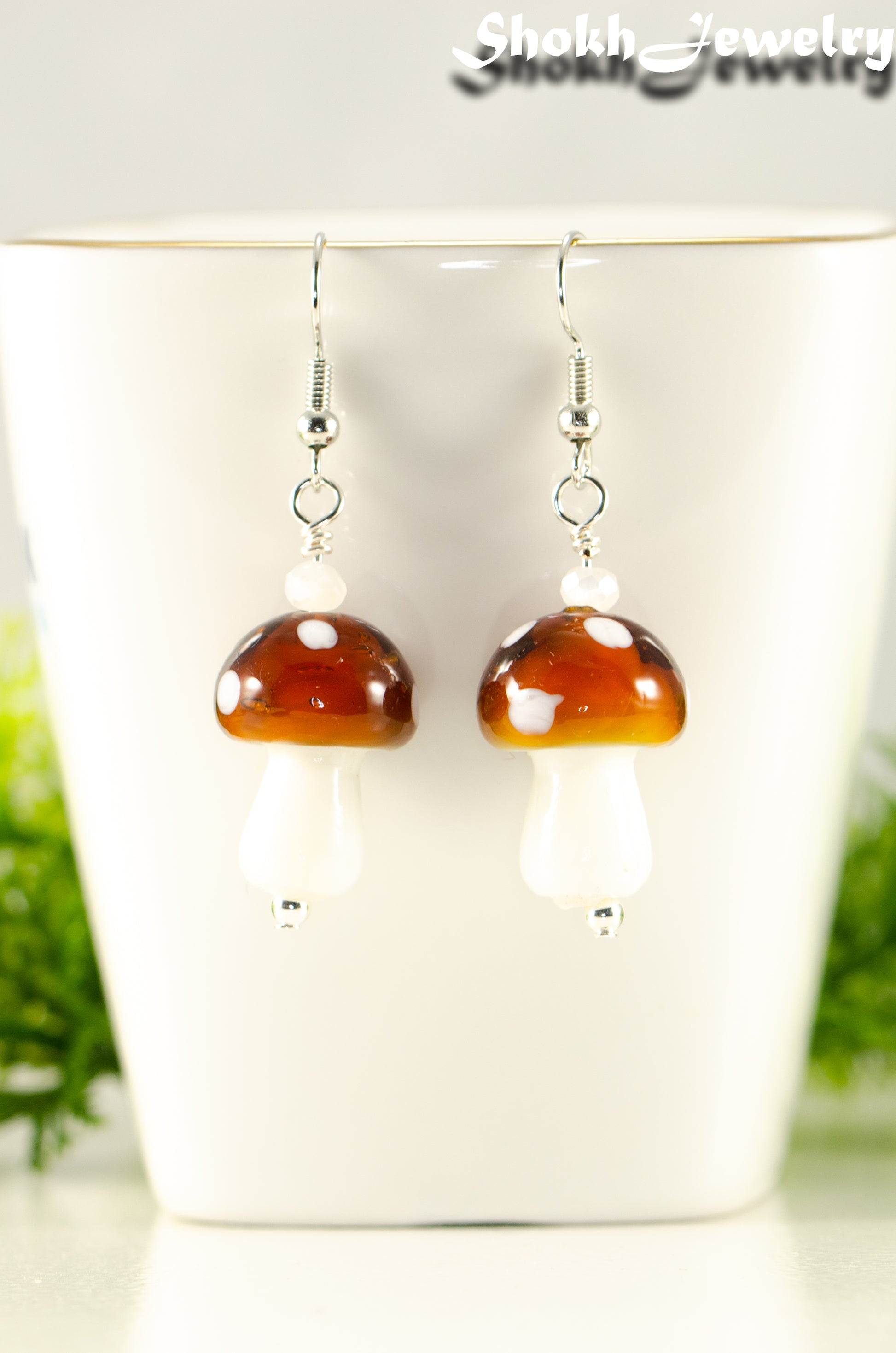 Close up of Brown Mushroom Glass Bead Earrings.