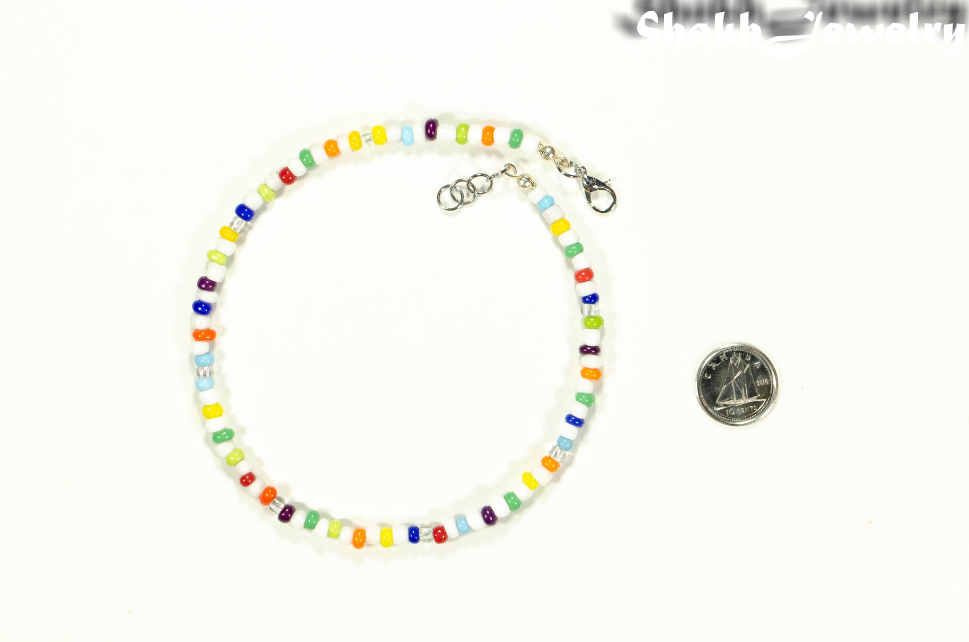 Multicolour Seed Bead Anklet beside a dime.