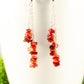 Close up of Long Silver Plated Chain and Red Coral Chip Earrings.