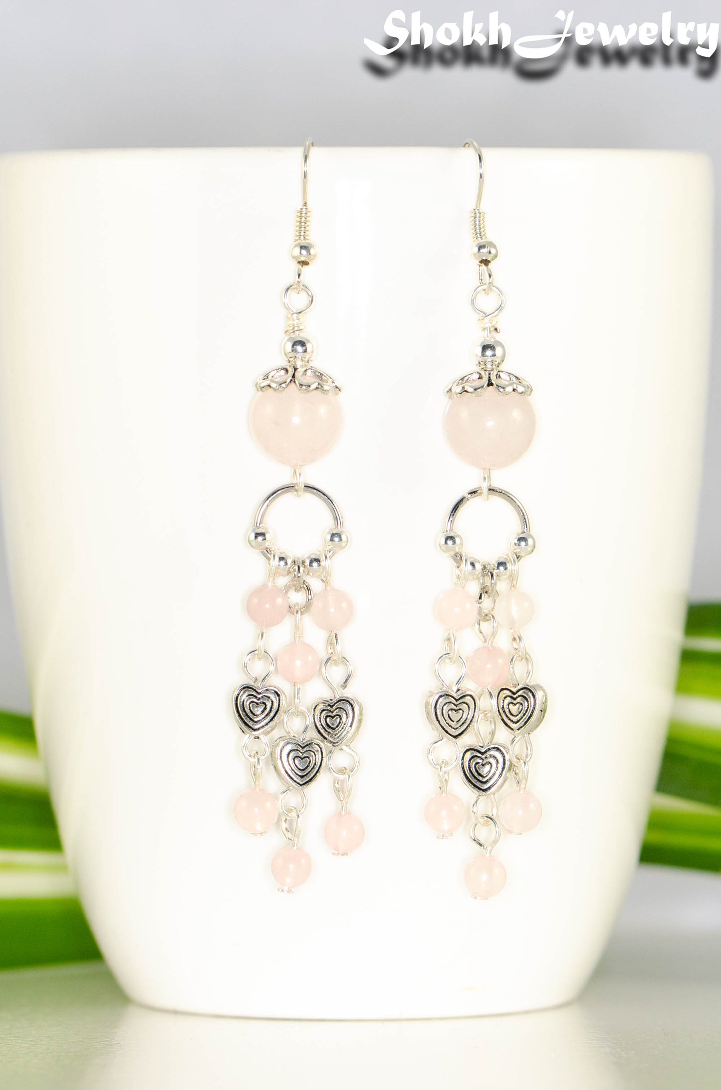 Close up of Statement Rose Quartz and Heart Chandelier Earrings.