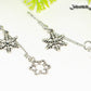 Close up of Long Chain and Snowflakes Charm Earrings.