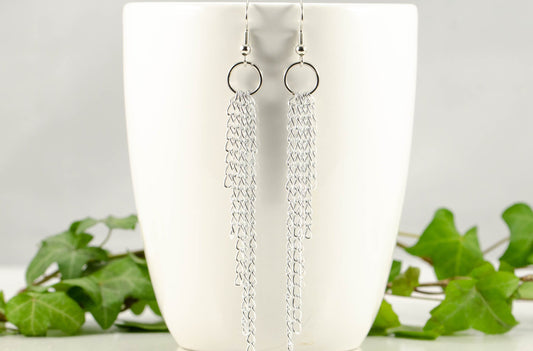 Extra Long Aluminum Chain Earrings displayed on a coffee mug.