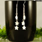 Long Silver Plated Chain and Seashell Star Earrings displayed on a coffee mug.