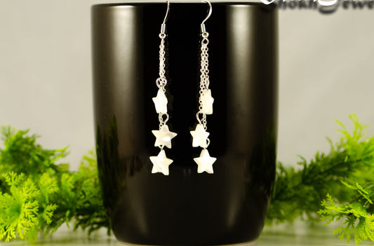 Long Silver Plated Chain and Seashell Star Earrings displayed on a coffee mug.