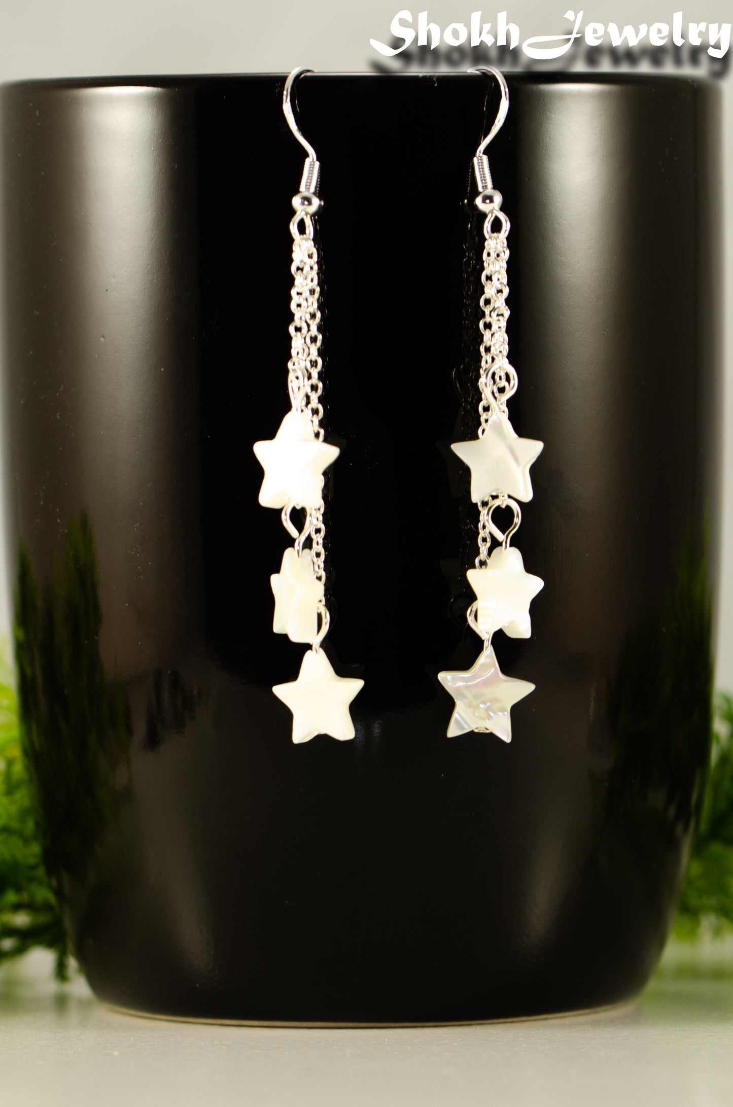 Close up of Long Silver Plated Chain and Seashell Star Earrings.