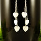 Close up of Long Silver Plated Chain and Seashell Heart Earrings.