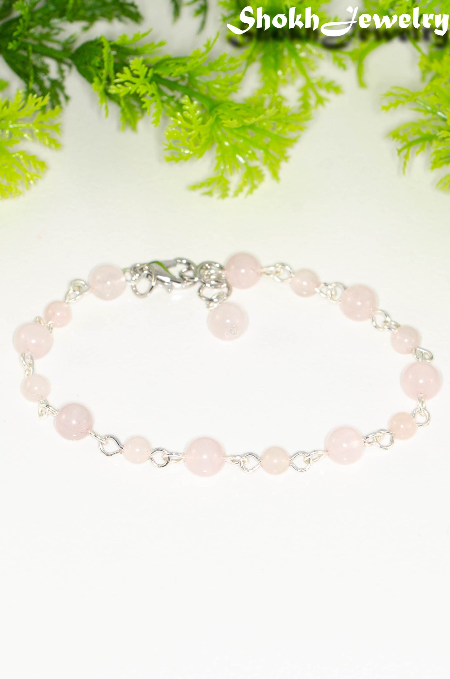 Close up of Handmade Rose Quartz Link chain anklet.