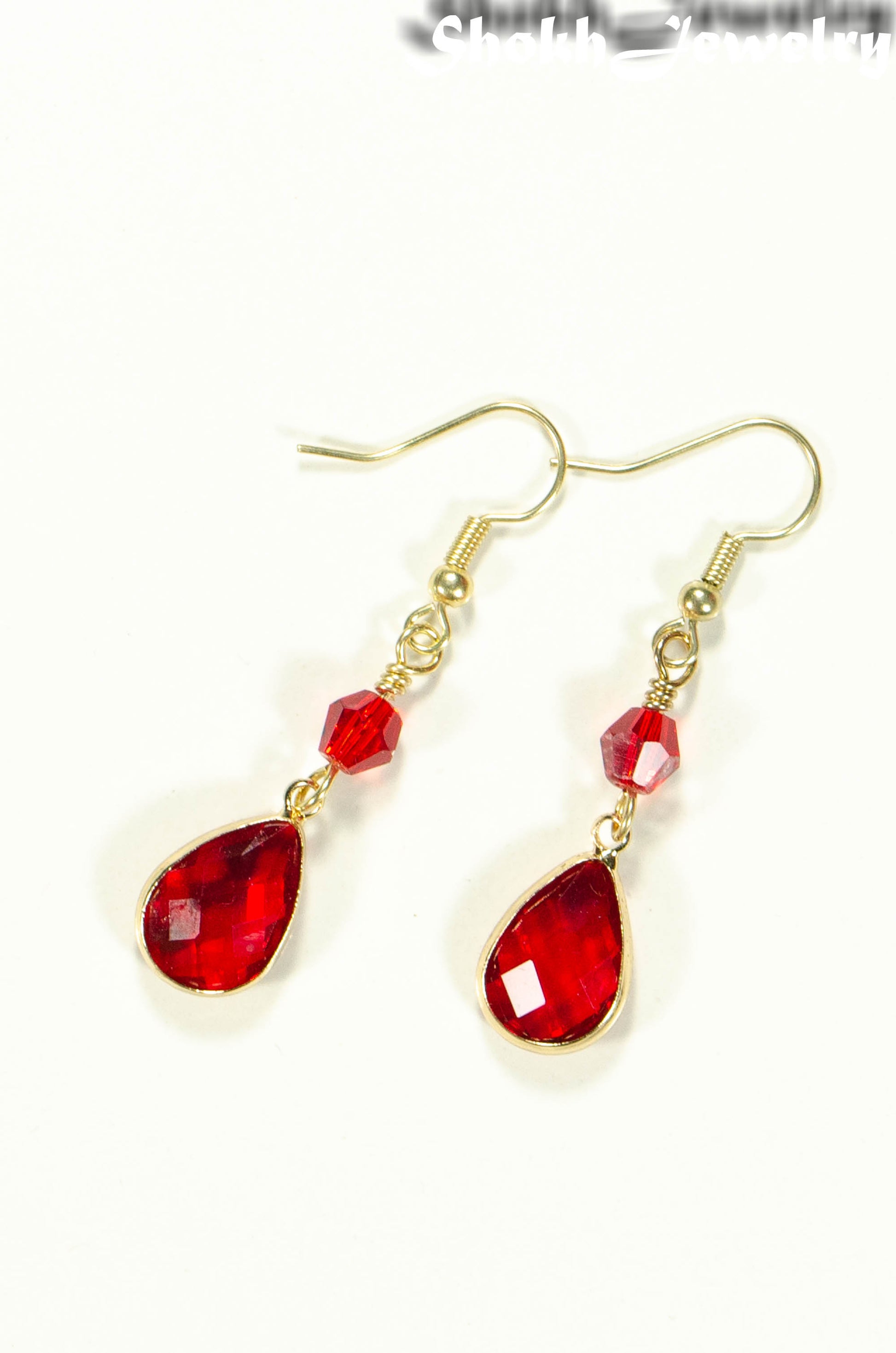 Top view of Red Glass Teardrop Dangle Earrings.