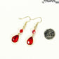 Red Glass Teardrop Dangle Earrings beside a dime.