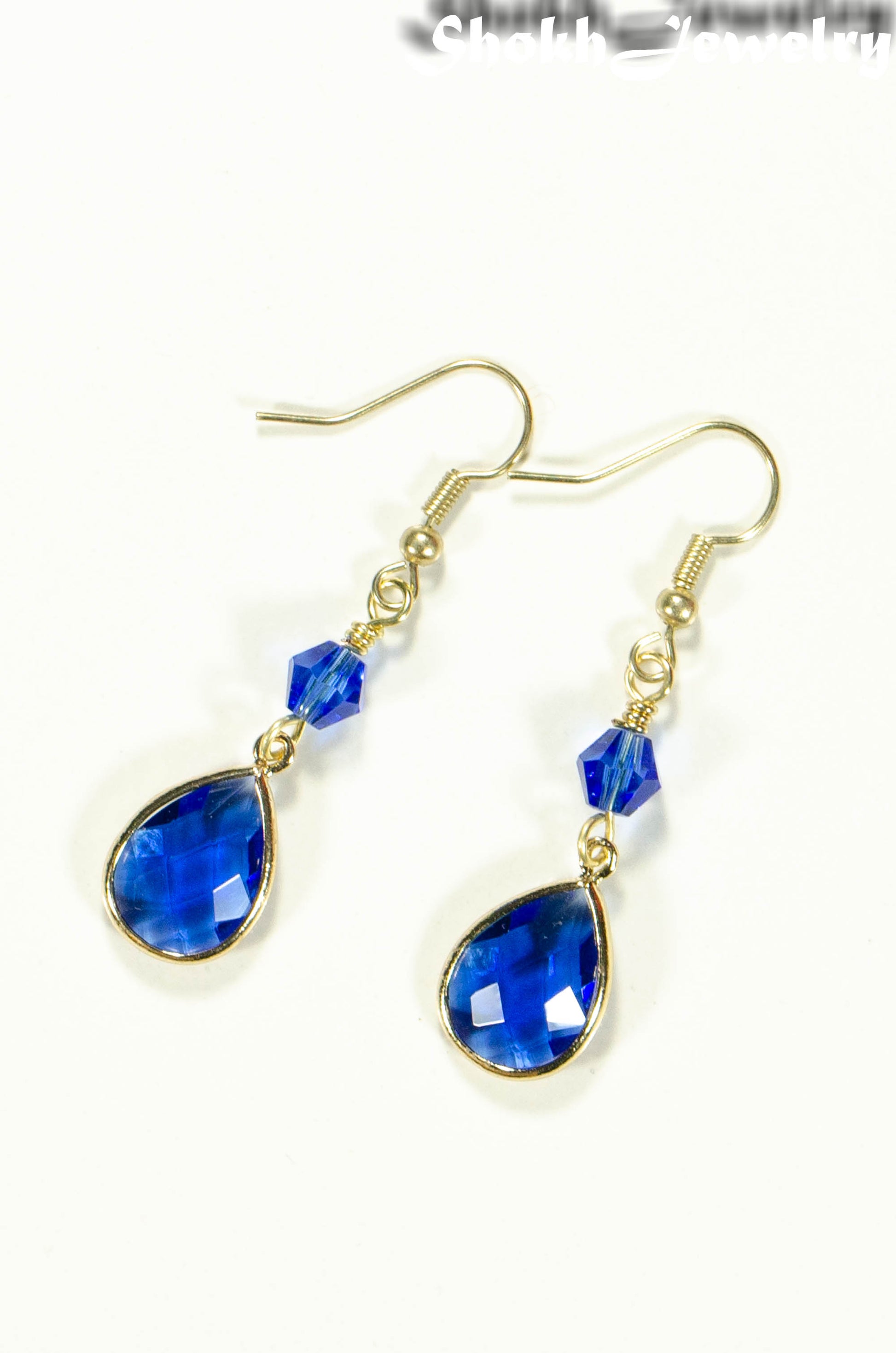 Top view of Blue Glass Teardrop Dangle Earrings.