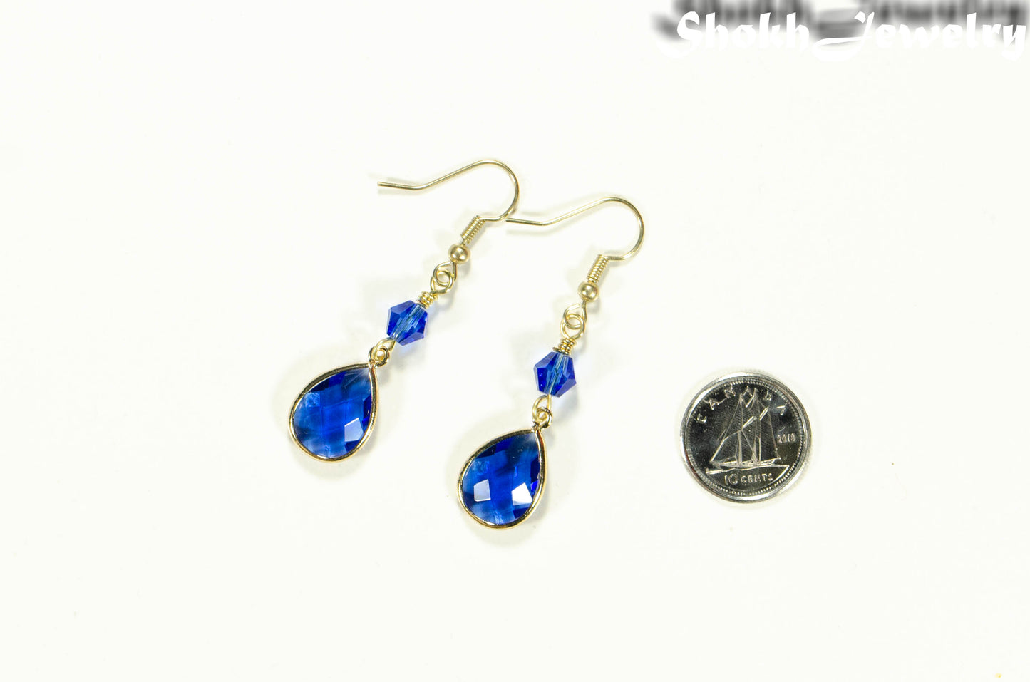 Blue Glass Teardrop Dangle Earrings beside a dime.