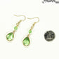 Green Glass Teardrop Dangle Earrings beside a dime.