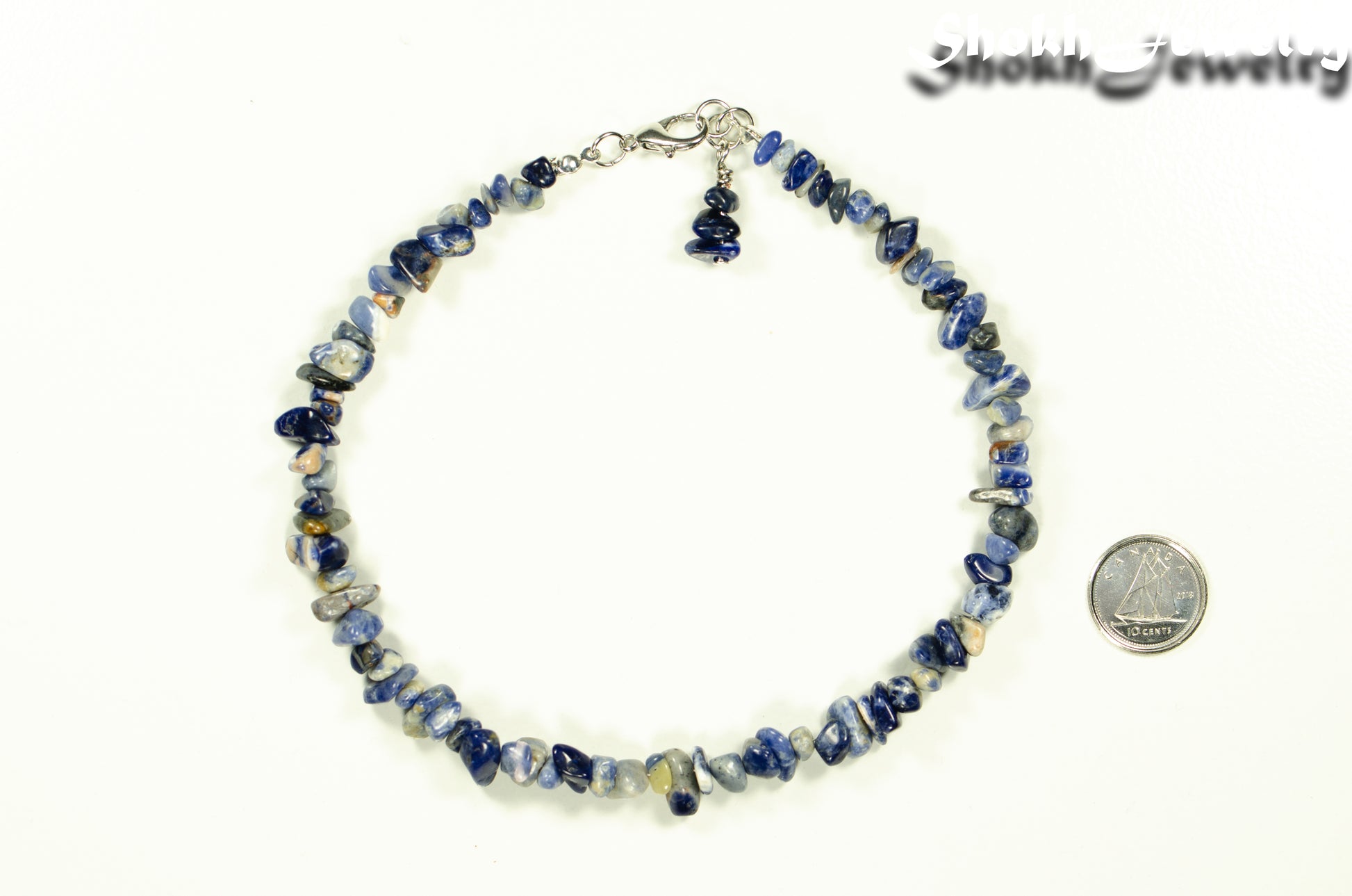 Natural Sodalite Crystal Chip Anklet beside a dime.