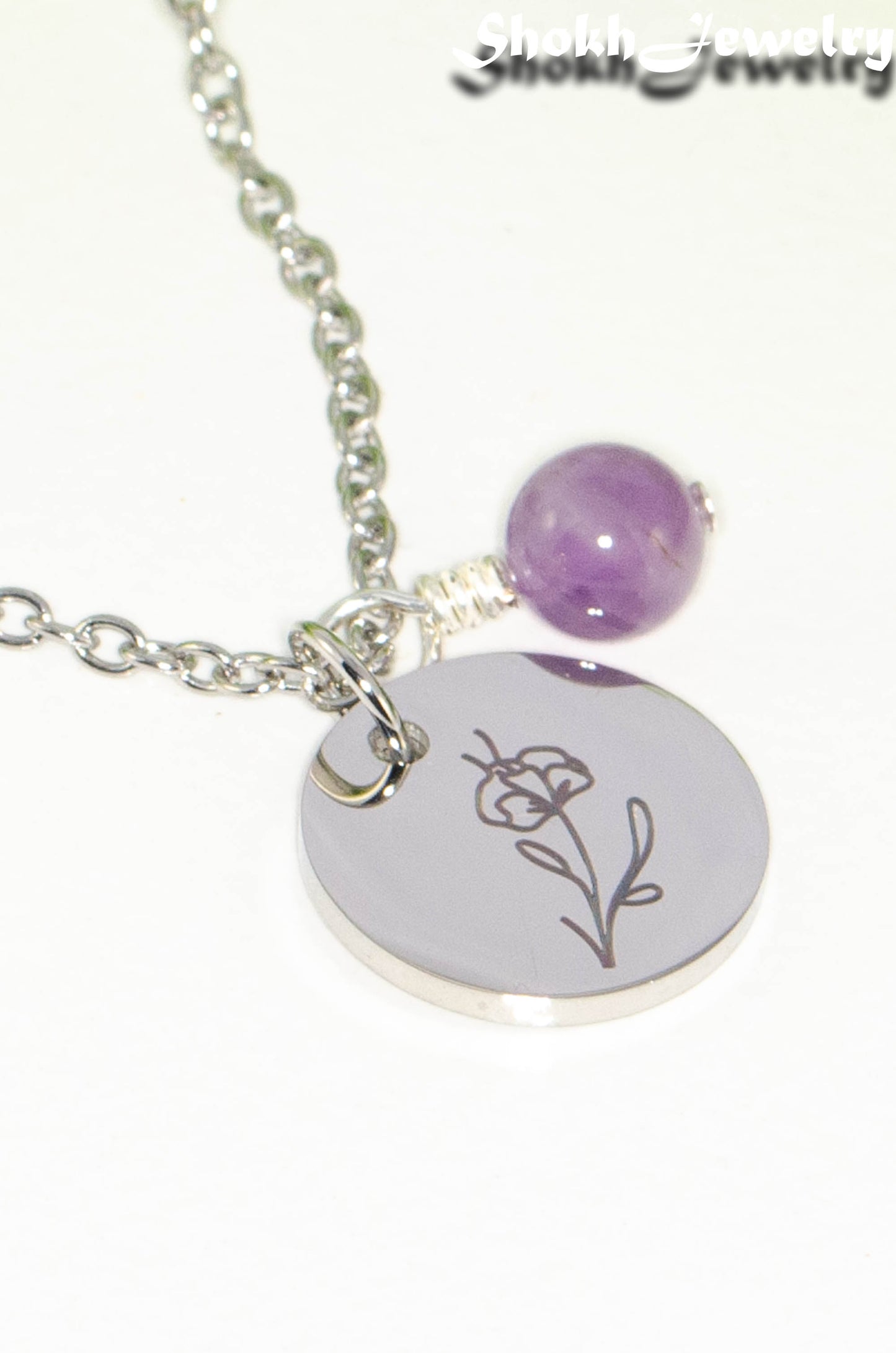 Close up of February Birth Flower Necklace with Amethyst Birthstone Pendant.