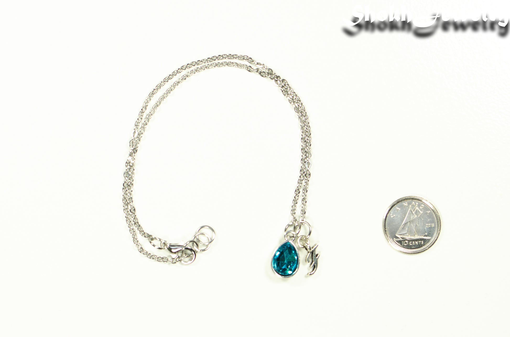 Small Personalized March Birthstone Choker Necklace beside a dime.