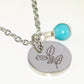 Close up of December Birth Flower Necklace with Turquoise Howlite Birthstone Pendant.