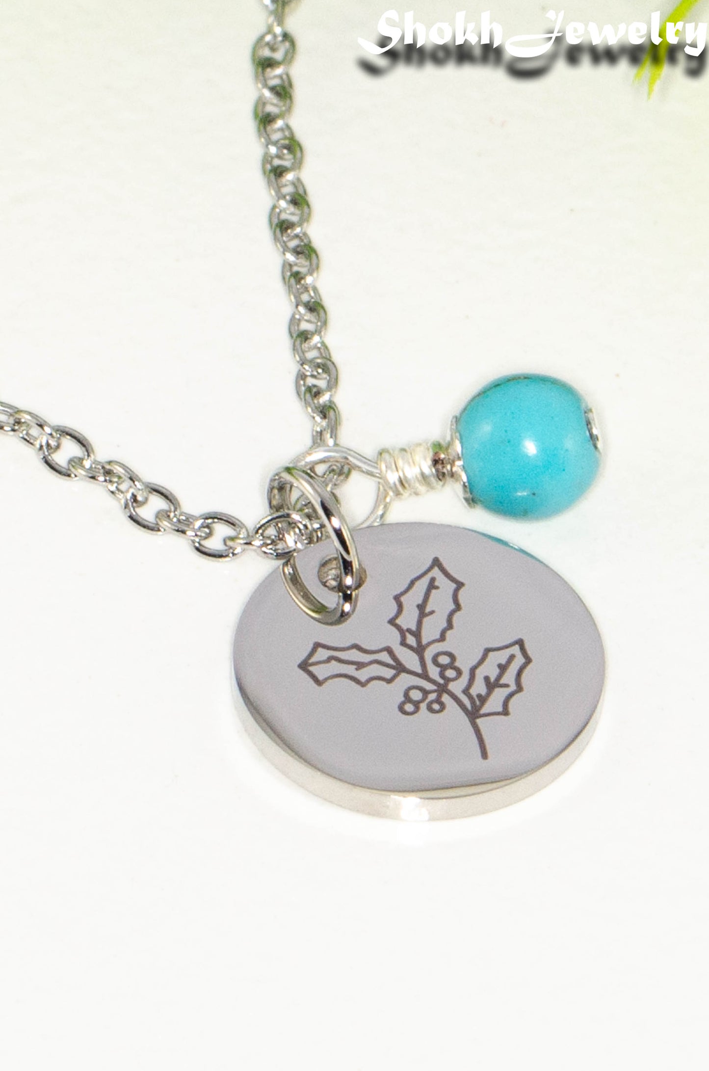 Close up of December Birth Flower Necklace with Turquoise Howlite Birthstone Pendant.