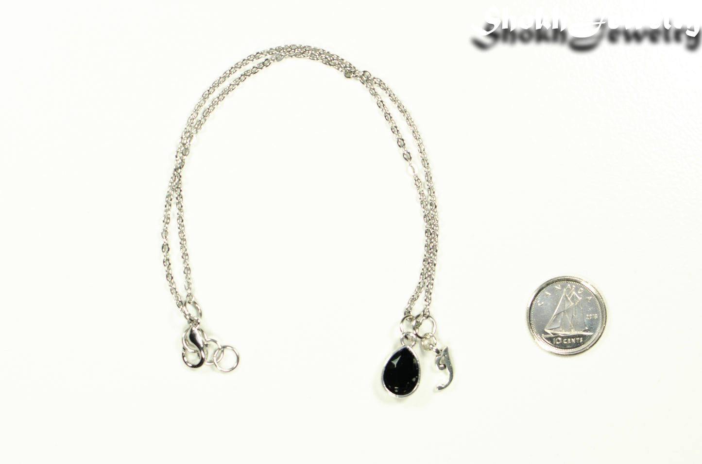 Small Personalized October Birthstone Choker Necklace beside a dime.