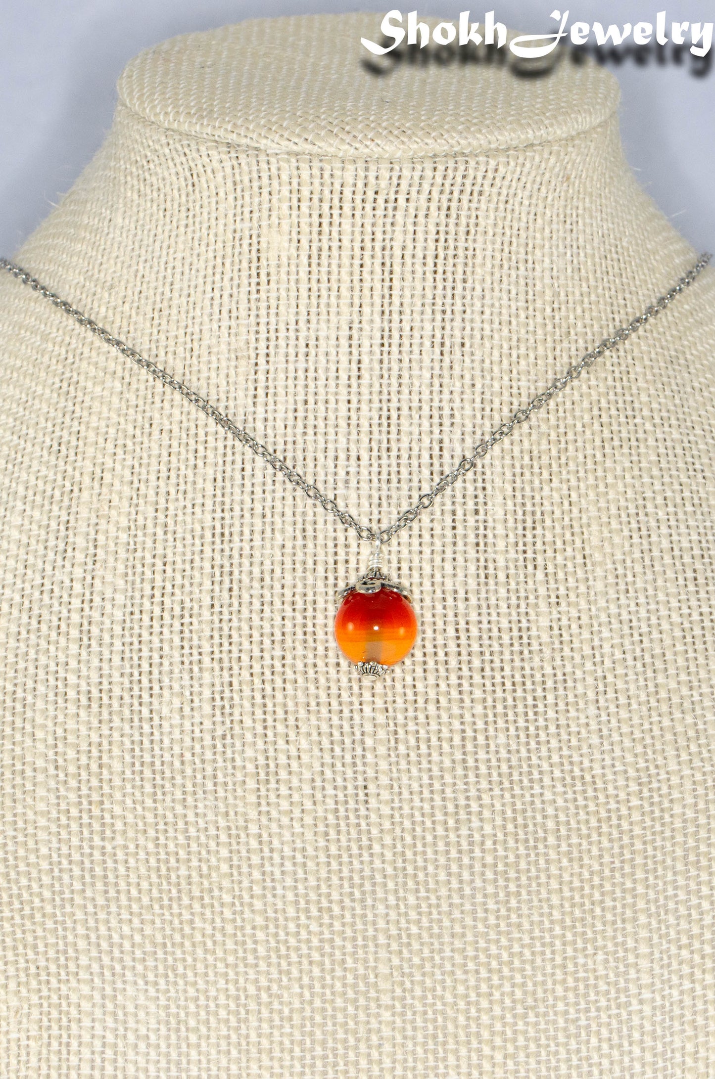 12mm Carnelian Pendant Necklace displayed on a bust.