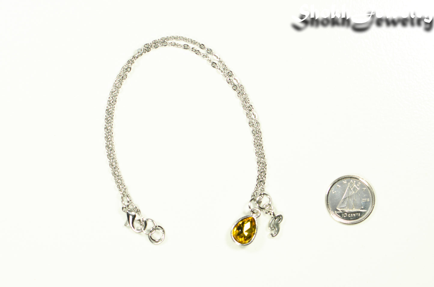 Small Personalized November Birthstone Choker Necklace beside a dime.