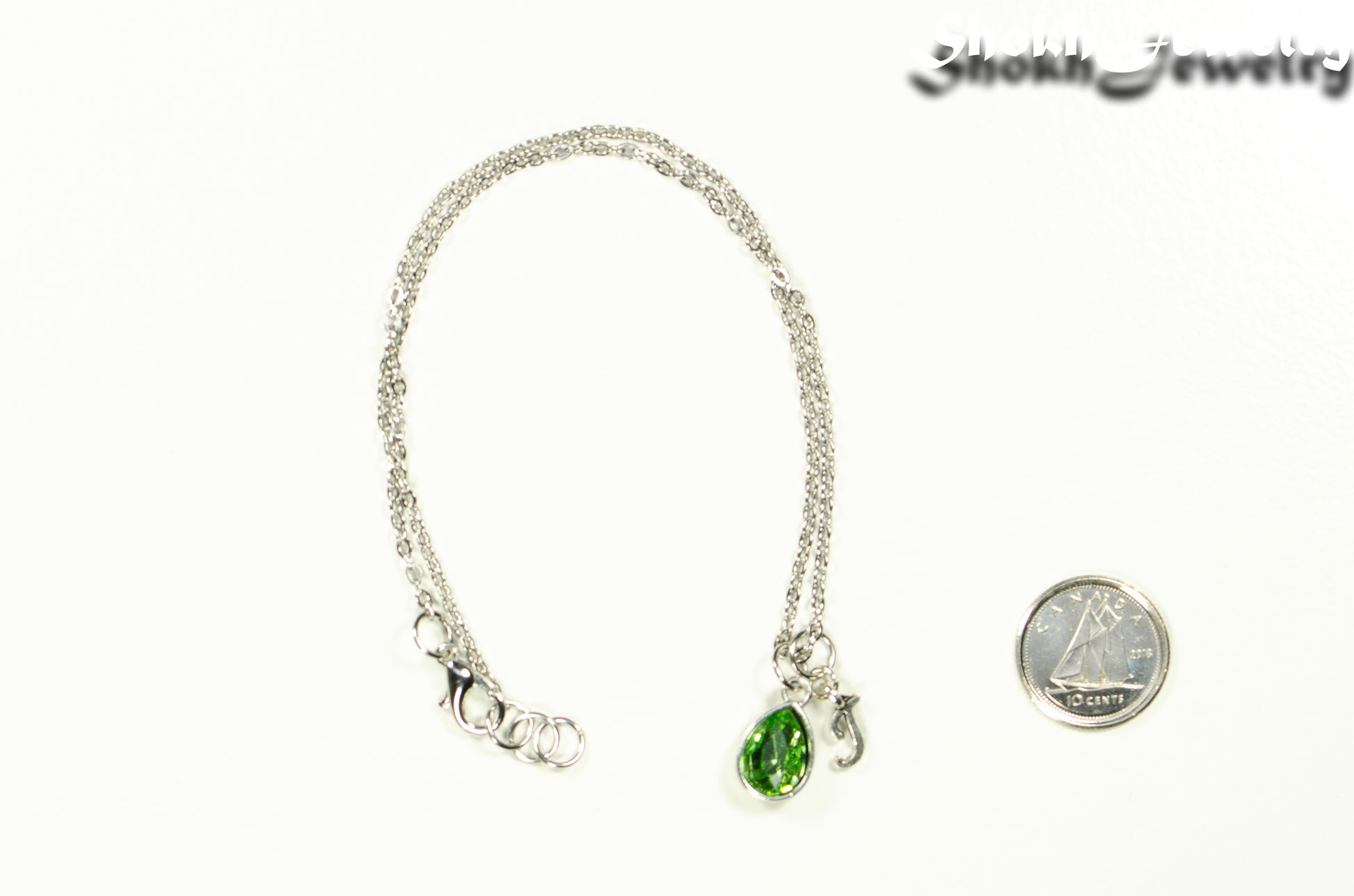 Small Personalized August Birthstone Choker Necklace beside a dime.
