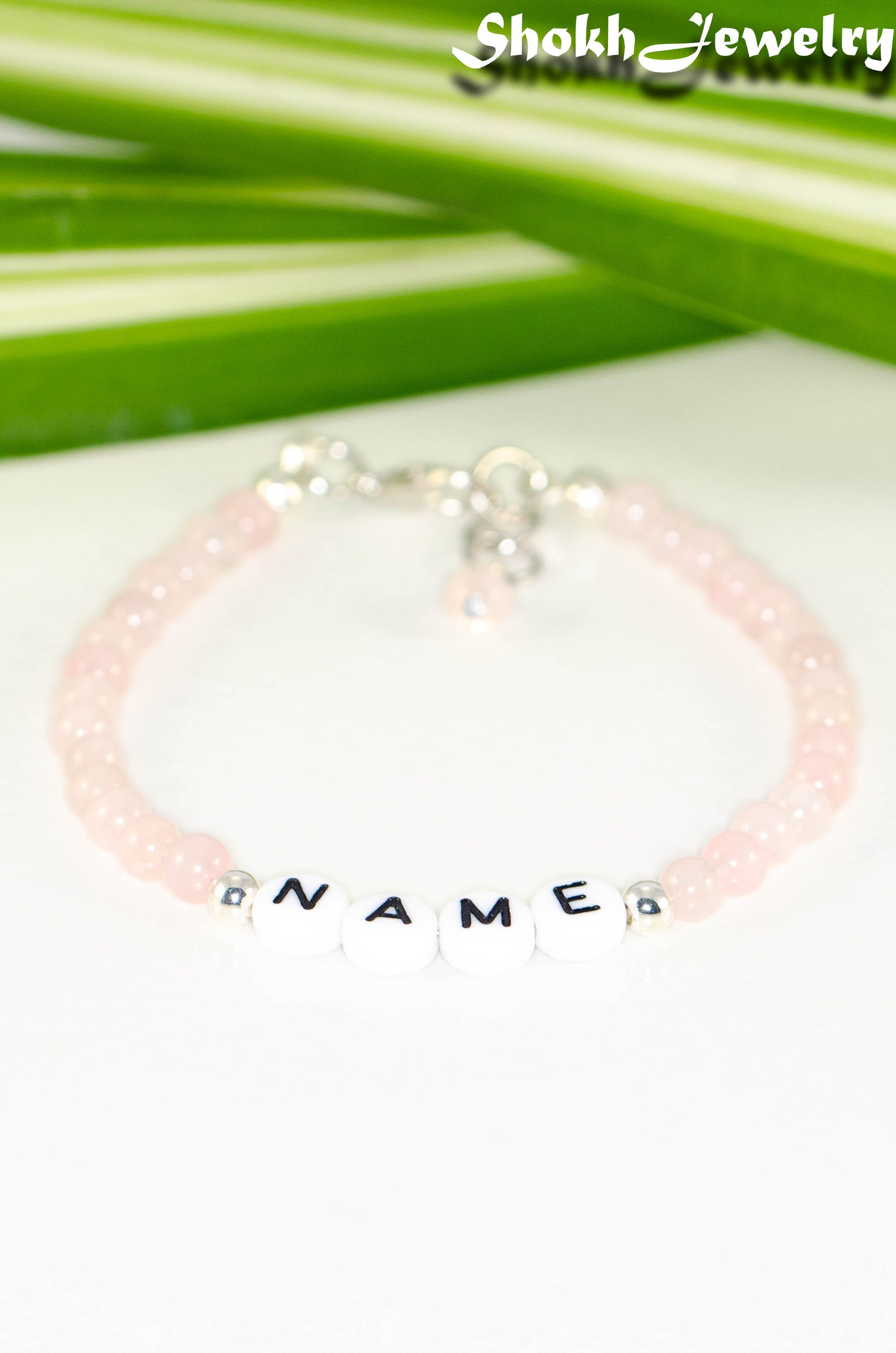 Close up of Personalized Rose Quartz Name Bracelet with Clasp.