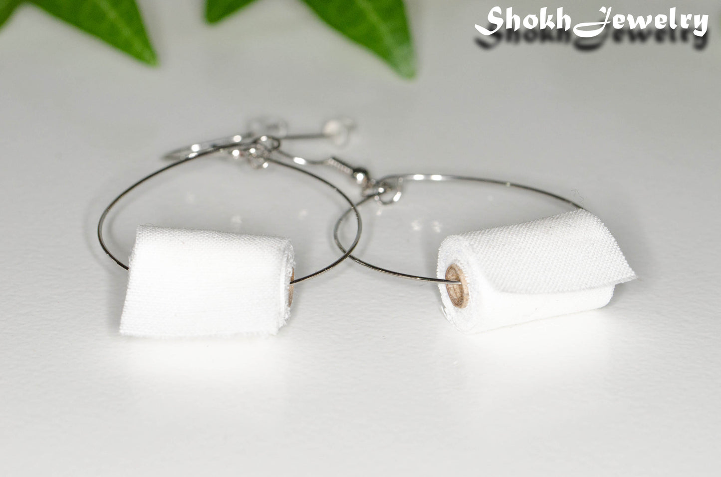 Close up of Large Miniature Toilet Paper Roll Earrings.