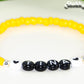 Close up of Yellow Seed Beads Name Bracelet.