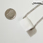 Miniature Toilet Paper Roll Necklace beside a dime.