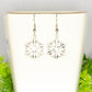 Close up of Christmas Snowflakes Charm Earrings.