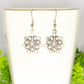 Close up of Christmas Snowflakes Charm Earrings.