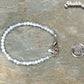 4mm White Opal anklet with Clasp beside a dime.