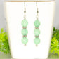 Natural Mint Green Quartz Beaded Bar Earrings displayed on atea cup.