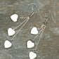 Top view of Long Silver Plated Chain and Seashell Heart Earrings.