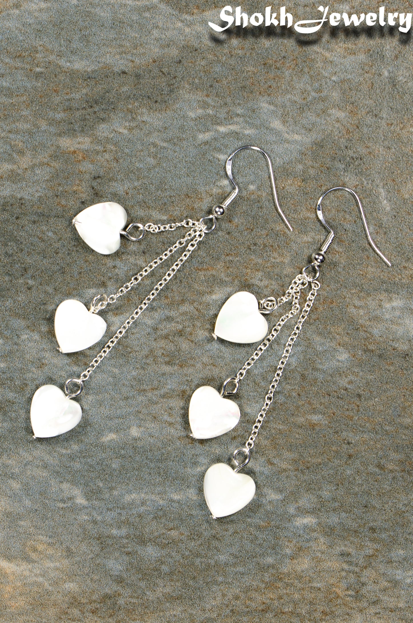 Top view of Long Silver Plated Chain and Seashell Heart Earrings.