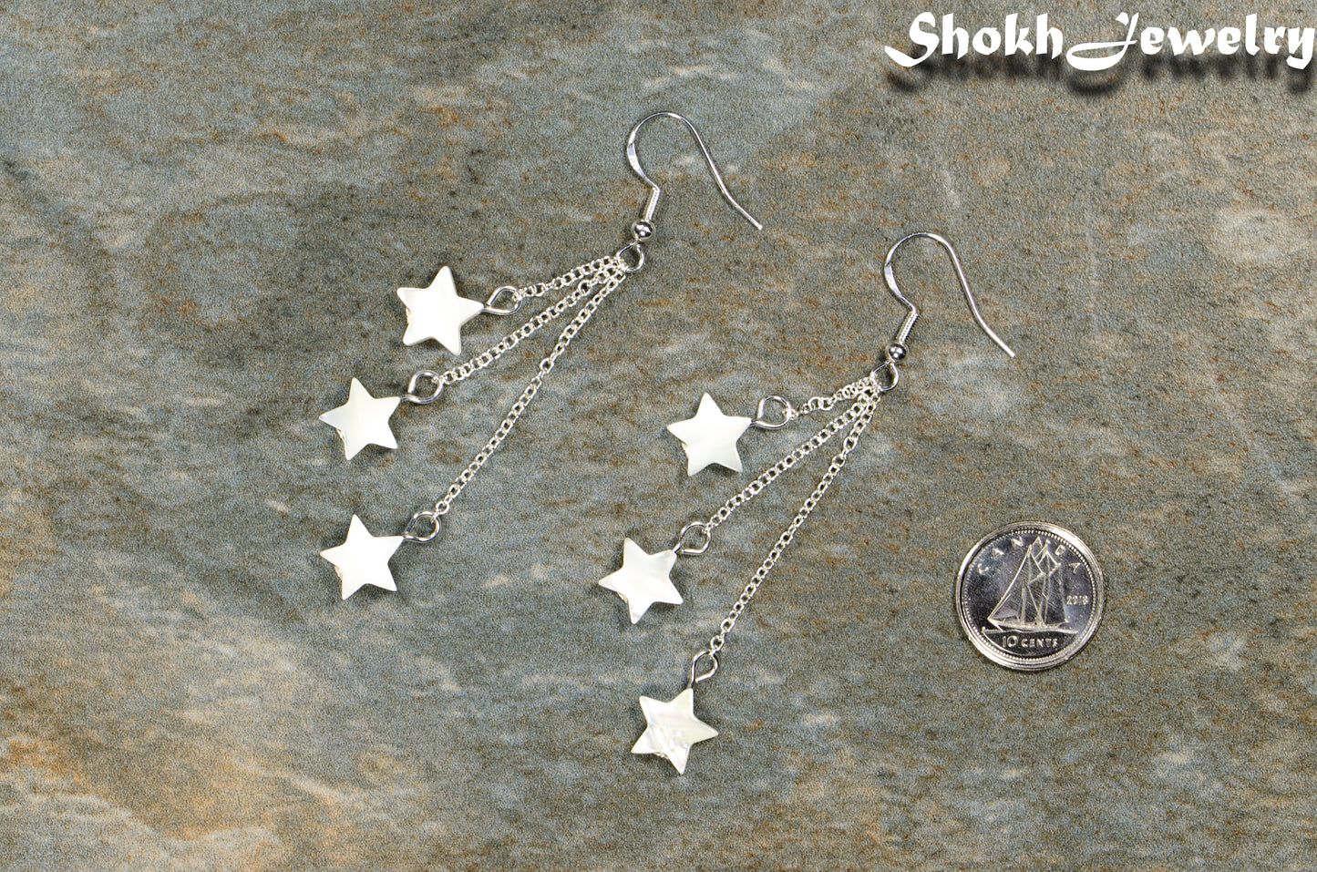 Long Silver Plated Chain and Seashell Star Earrings beside a dime.