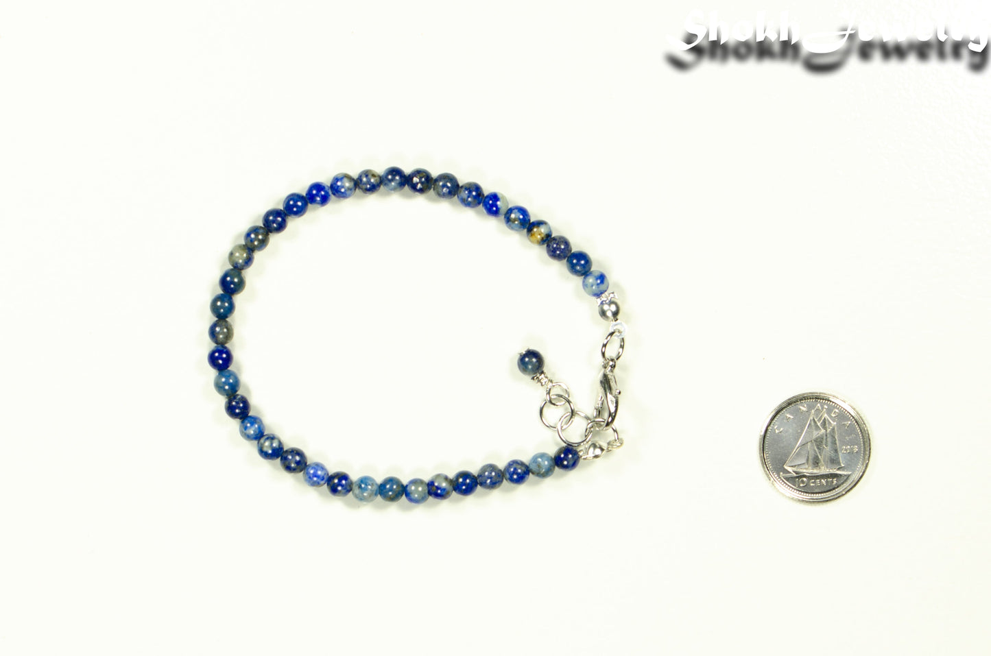 4mm Lapis Lazuli Anklet with Clasp beside a dime.