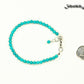 4mm Turquoise Stone Bracelet with Clasp beside a dime.
