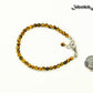 4mm Tiger's Eye anklet with Clasp beside a dime.