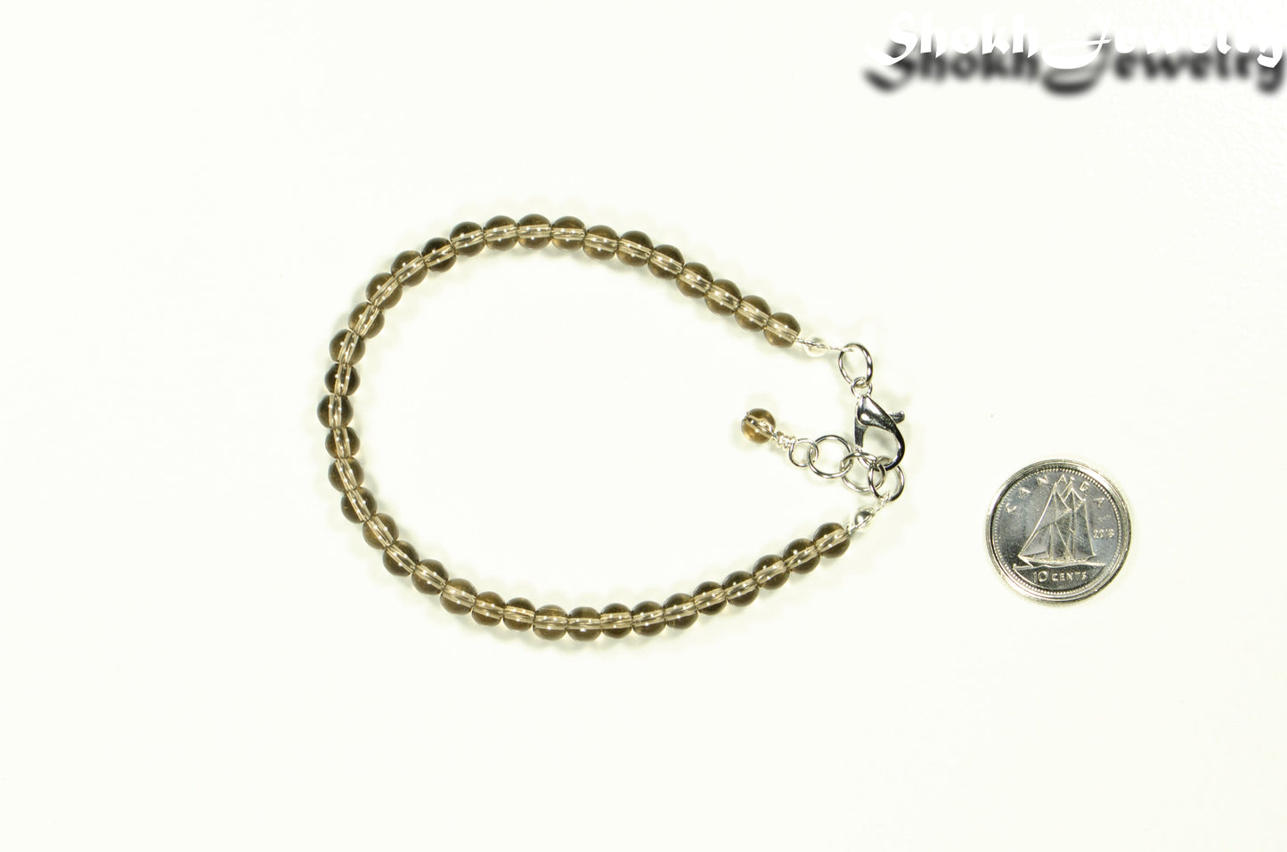 4mm Smoky Quartz anklet with Clasp beside a dime.