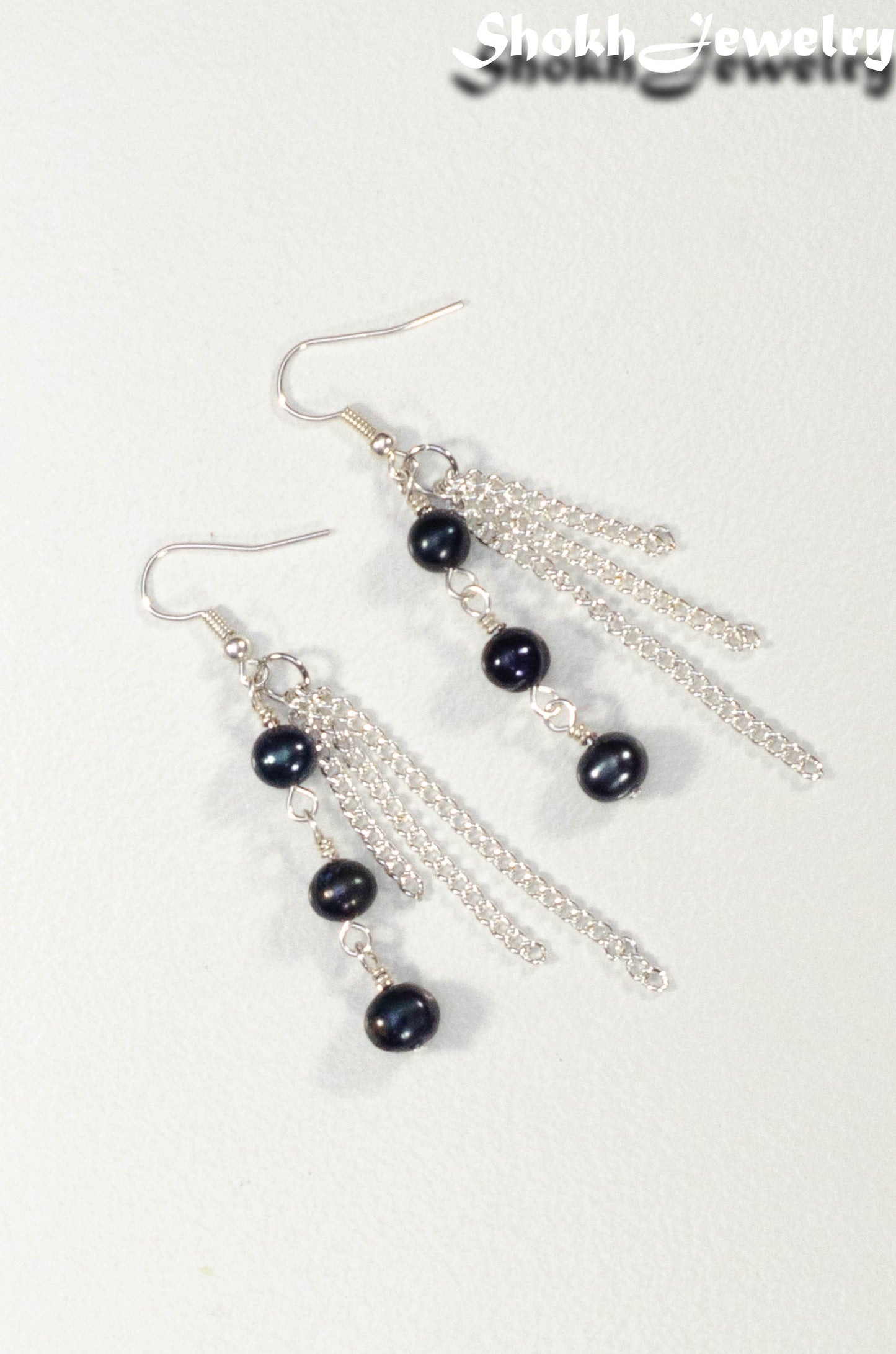 Top view of Long Chain and Black Freshwater Pearls Earrings.