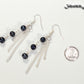 Long Chain and Black Freshwater Pearls Earrings beside a dime.