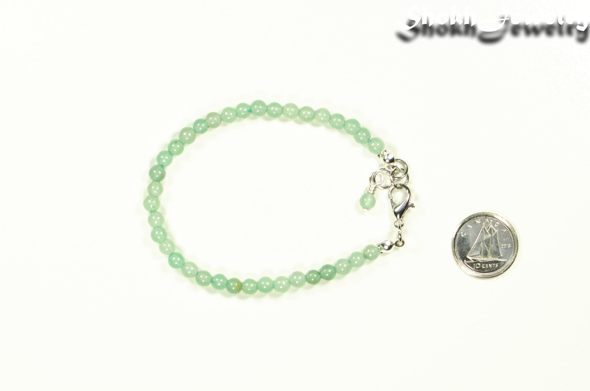 4mm Green Aventurine anklet with Clasp beside a dime.