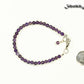 4mm Amethyst Bracelet with Clasp beside a dime.