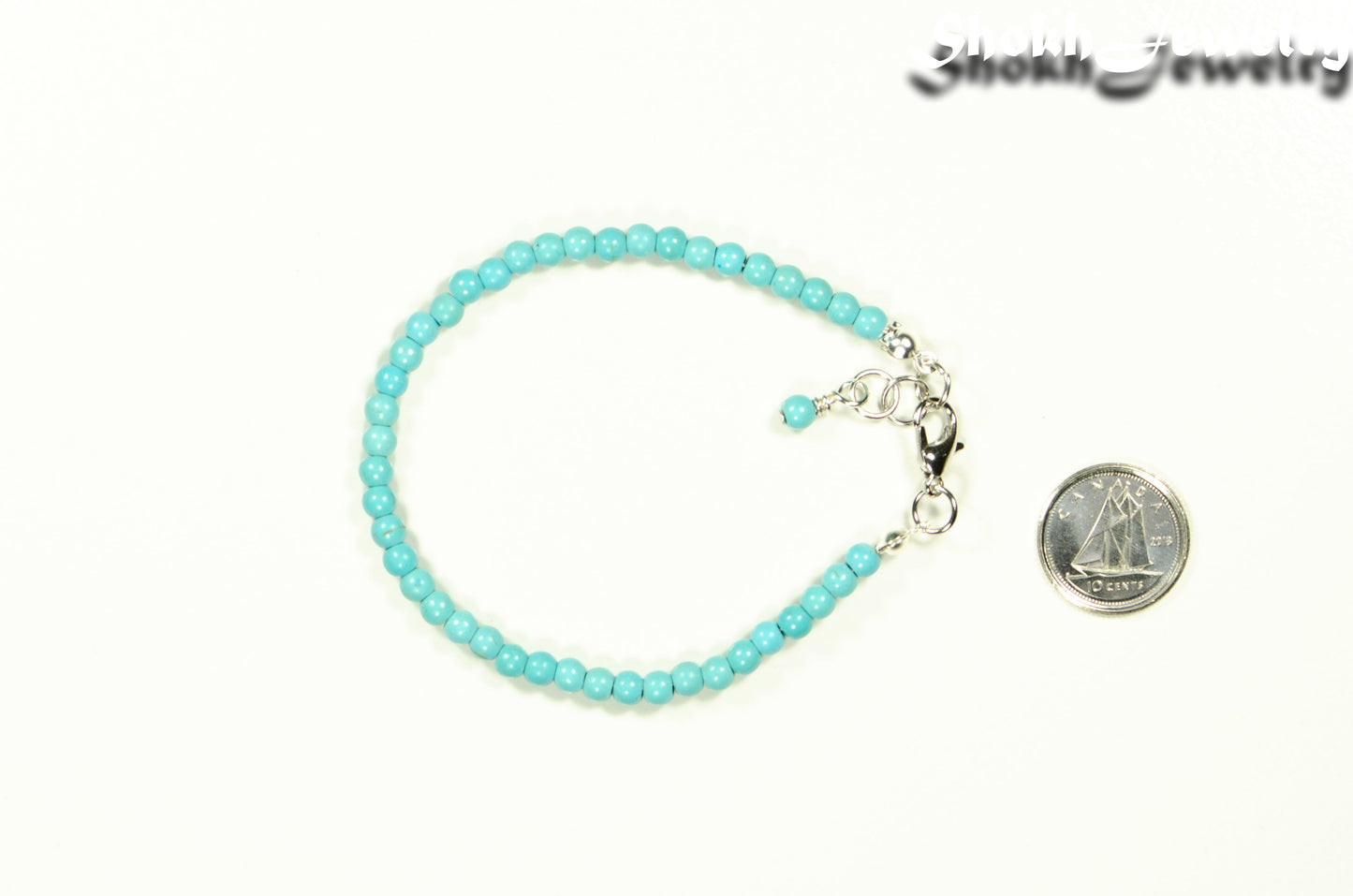 4mm Turquoise Howlite Anklet with Clasp beside a dime.