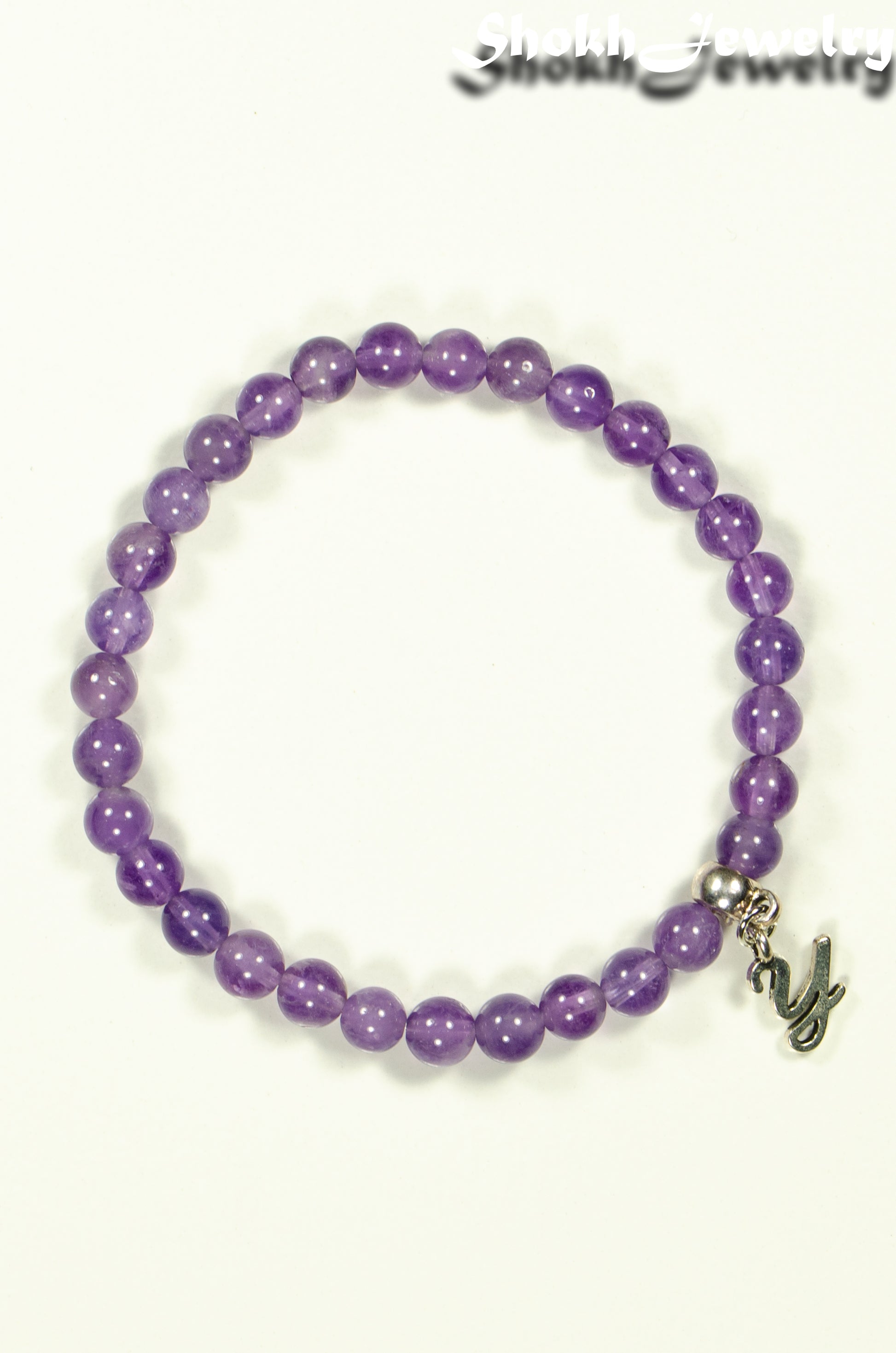 Top view of 6mm Amethyst Bracelet with Initial.