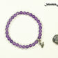 6mm Amethyst Bracelet with Initial beside a dime.