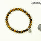 6mm Tiger's Eye Bracelet with Initial beside a dime.